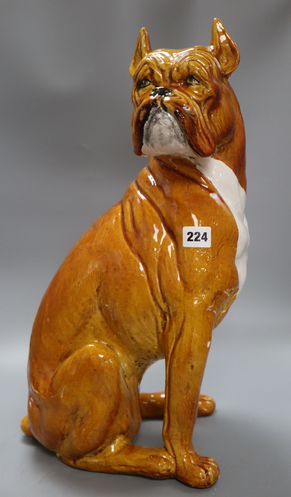 A large tinglaze pottery figure of a boxer dog, height 50cm